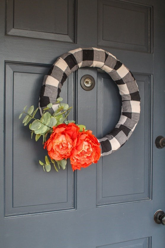 Make an easy buffalo plaid modern farmhouse wreath. It's the perfect way to upcycle a plaid shirt or simply buy a bit of buffalo plaid fabric.