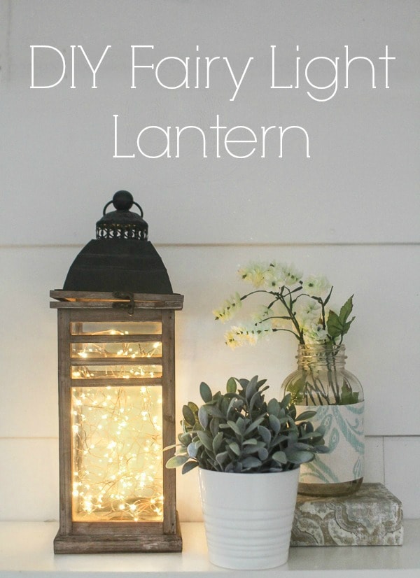 DIY fairy light shown on counter with plant and vase of flowers.