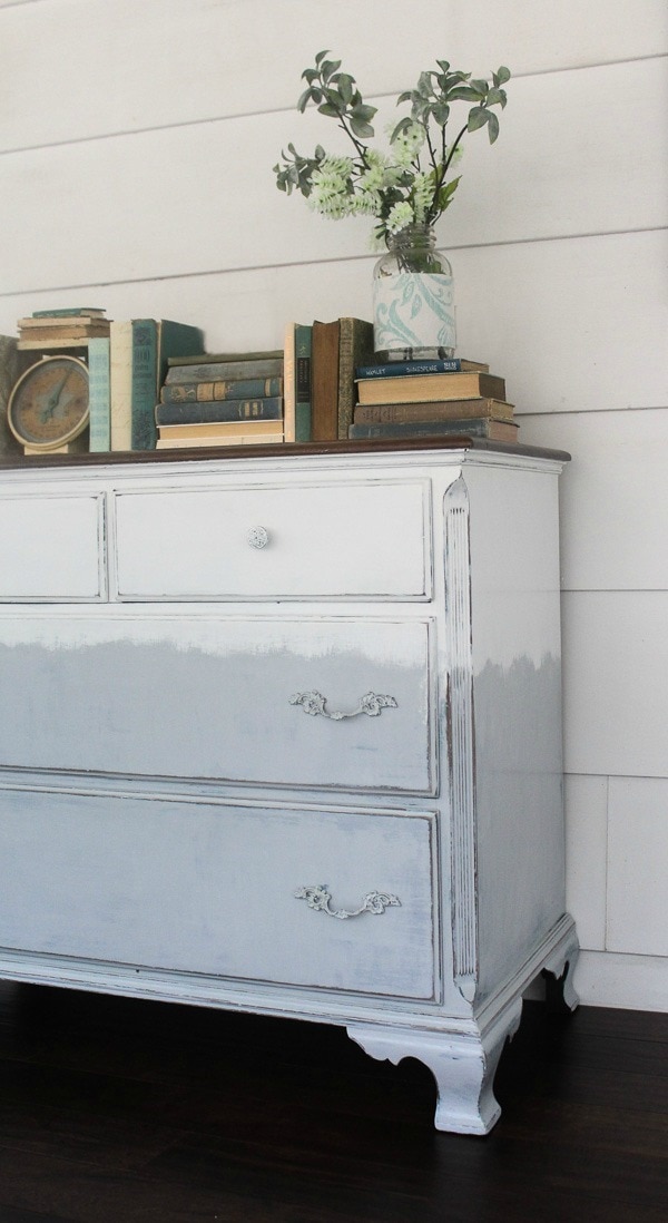 Faded painted dresser in gray and white. A touch or modern farmhouse style plus a touch of boho.