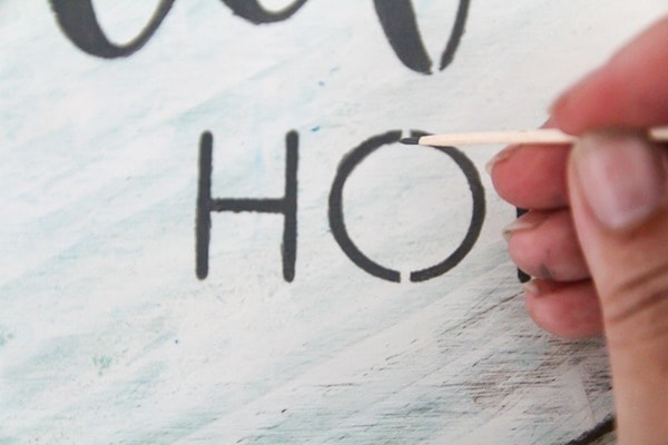 How to easily fill in the gaps in a stenciled design to get a hand-painted sign look using a stencil. how to fill in stencil gaps with a toothpick.