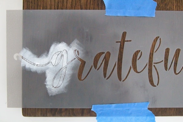 stenciling on wood with a grateful stencil.