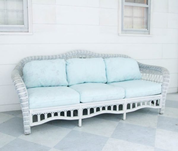 white wicker couch with painted cushions