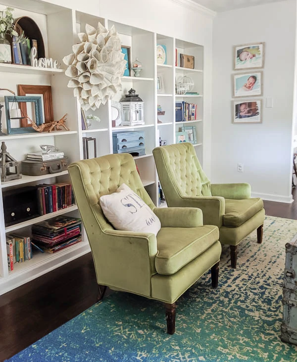 armchairs and rug in front of IKEA billy built-in bookcases