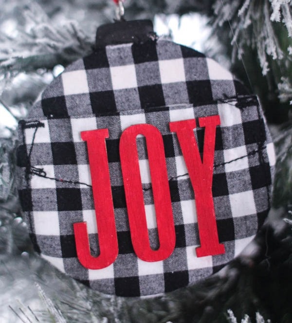 diy black and white buffalo plaid ornament hanging on christmas tree.