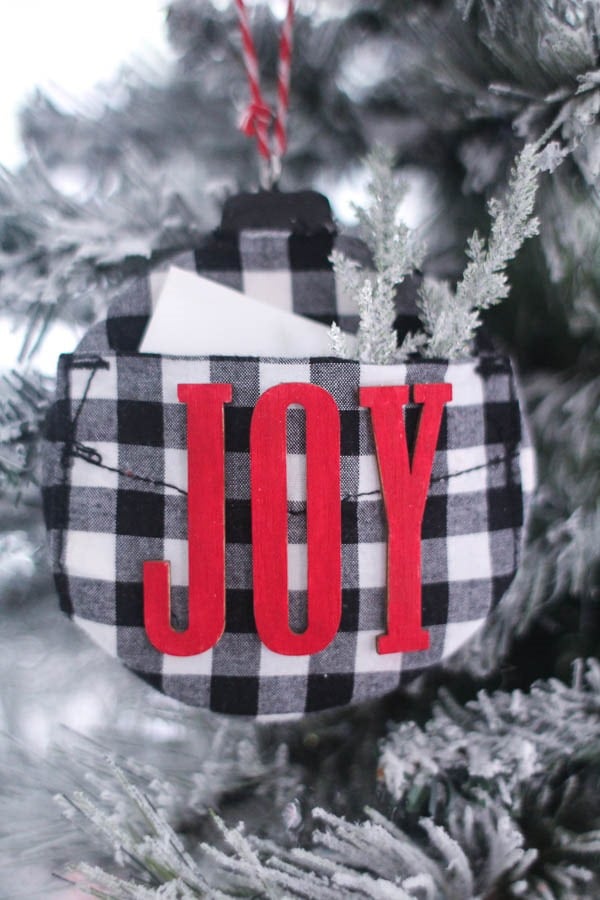 DIY buffalo plaid ornament with letters spelling joy.