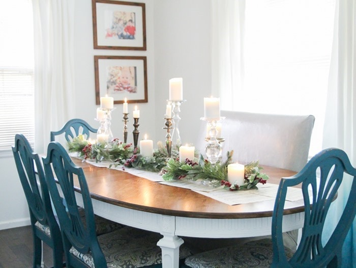 Christmas tablescape with framed photos from Christmas' past in the background.