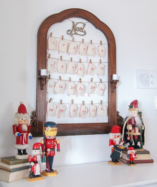 DIY Christmas countdown made from an antique frame and small muslin bags.