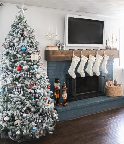 DIY flocked Christmas tree next to mantel with stockings.