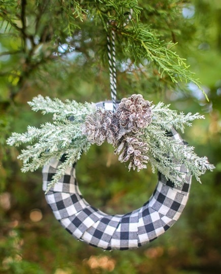 DIY buffalo plaid Christmas ornament hanging on Christmas tree.