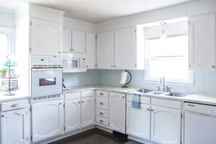 Kitchen with stenciled backsplash and painted countertop