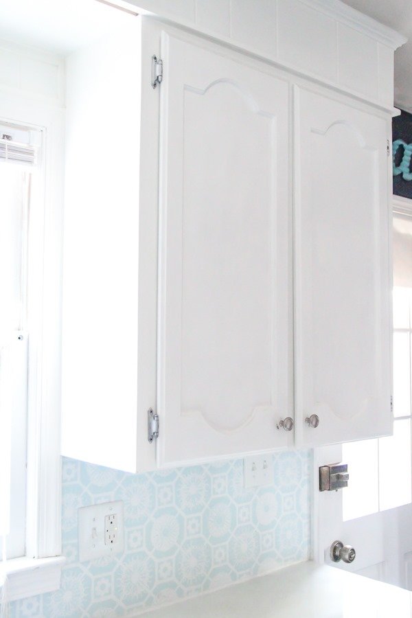 white painted cabinets with small chips