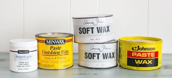different brands of furniture wax including americana decor creme wax, minwax paste wax, annie sloan soft wax, and johnson paste wax.