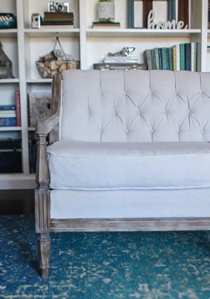 Vintage sofa with a tufted back reupholstered using drop cloth.