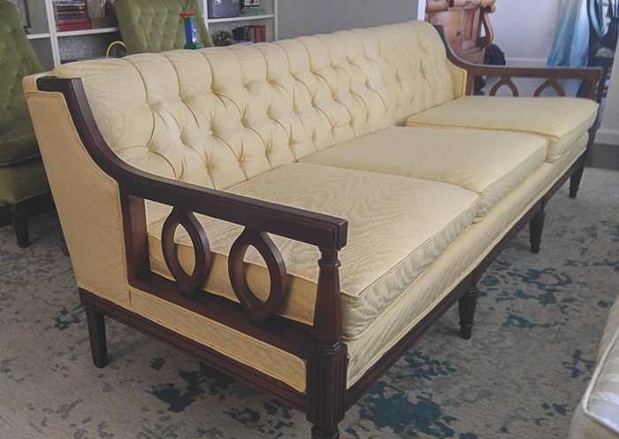 vintage couch with shiny yellow upholstery before reupholstery