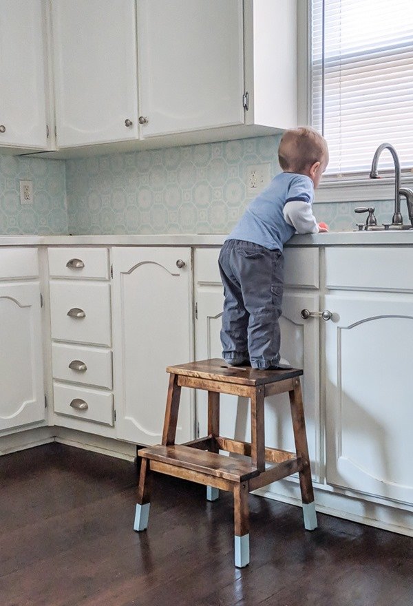 Ikea step stool makeover - color dipped stool with toddler standing on it to reach sink