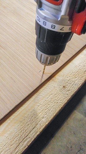 drilling holes for screws to attach chalkboard to frame