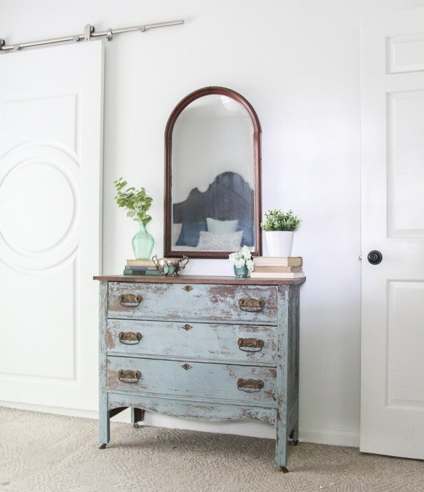 A chippy blue dresser and vintage mirror make a perfect pair for a bedroom or hallway.
