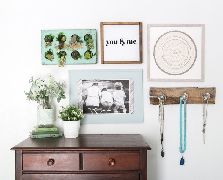 Gallery wall with lots of texture above dresser.