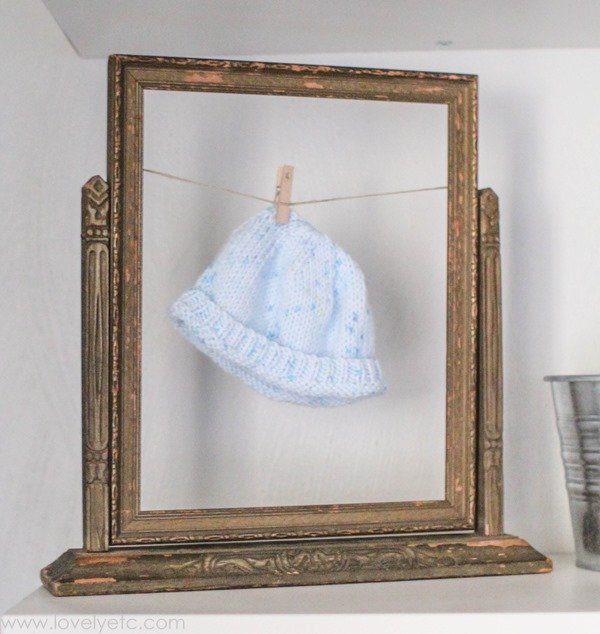 Easy nursery art - display a newborn hat in a vintage frame