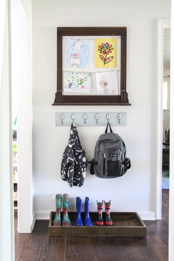 Create a mini mudroom in a tiny space with a backpack station, shoe storage, and a spot to display kids artwork.