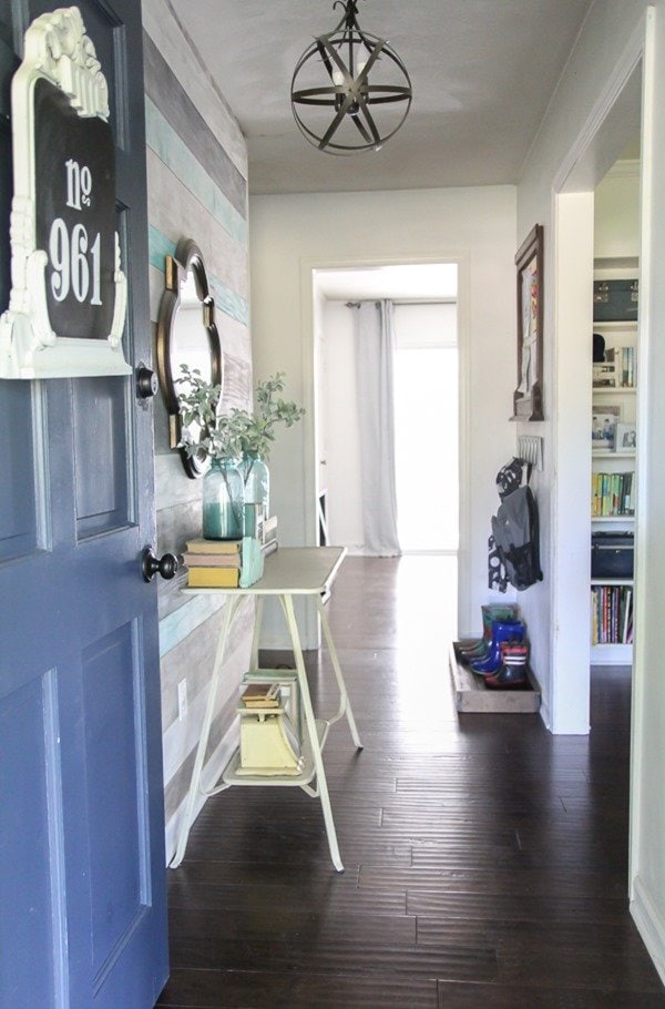 entryway with blue front door and diy orb chandelier