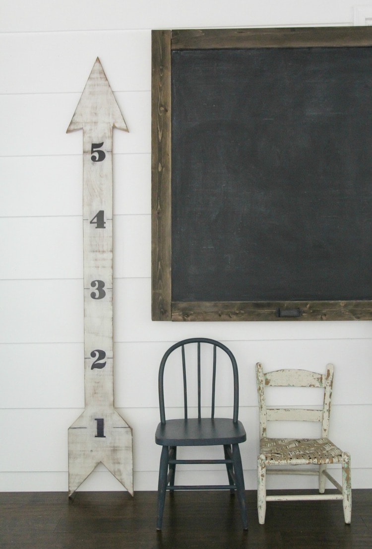 Adorable DIY wooden arrow growth chart with large numbers.