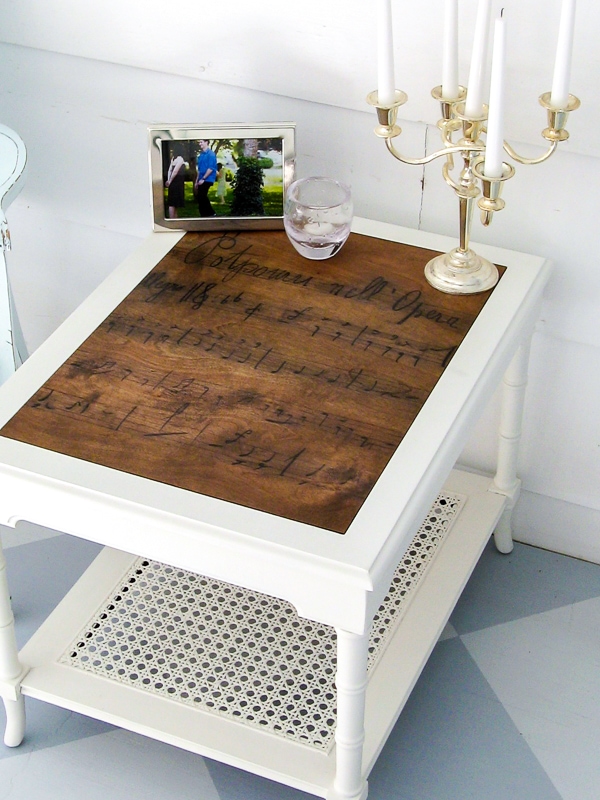 End table with a plywood top with a sheet music design transferred onto it.