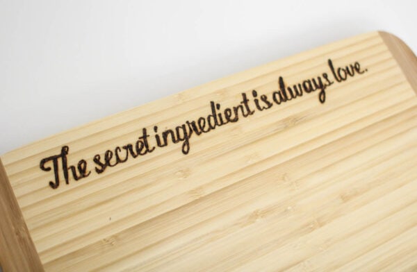 Cutting board with custom DIY wood burned phrase.