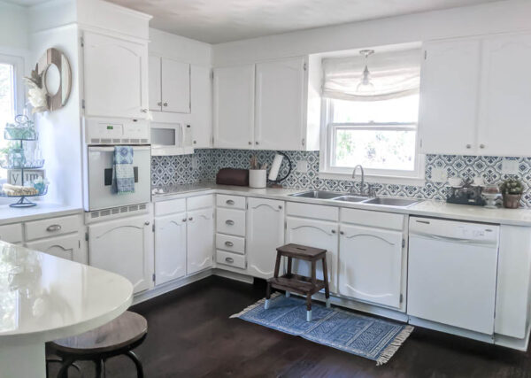 Modern Farmhouse Kitchen makeover on a budget. This entire space cost less than $1000 including appliances! Get lots of tips for saving money and using DIY updates to completely transform your space