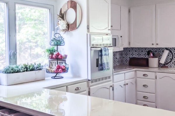 kitchen with white painted cabinets and painted countertops.