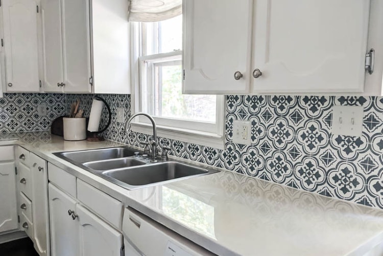 Close up of painted laminate countertops and stenciled backsplash