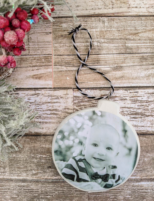 DIY photo ornament with black and white photo of a baby to celebrate baby's first Christmas.