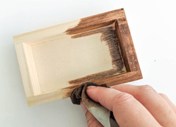 staining the mini sign frame with a clean rag.