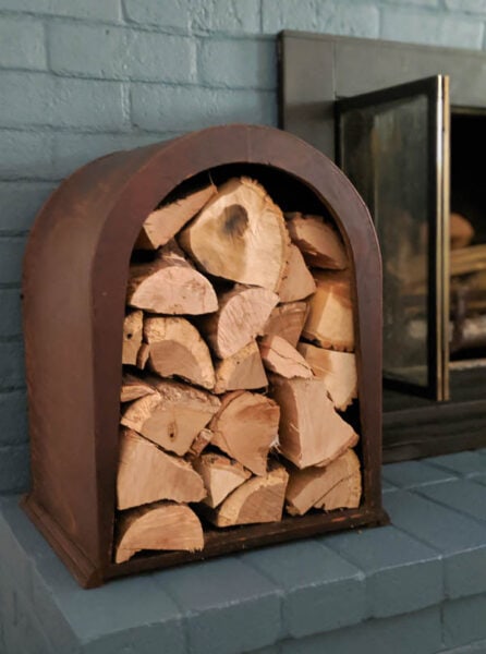 This upcycled firewood holder looks beautiful next to the fireplace. This is such a fun way to store firewood for your next fire and it was upcycled from an old vintage item nobody wanted anymore.