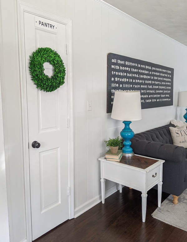 pantry door with sign and wreath.