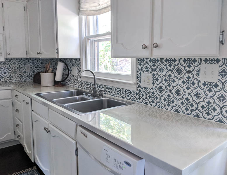 kitchen with blue and white stenciled backsplash