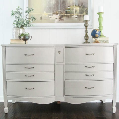 painted dresser shown with art and vases