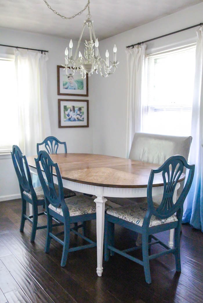 dining table with a refinished top and white legs with chairs painted blue.