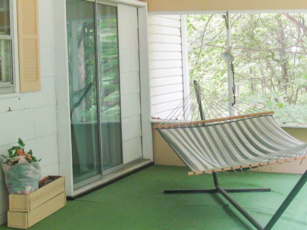 screened-in porch with green astroturf floor