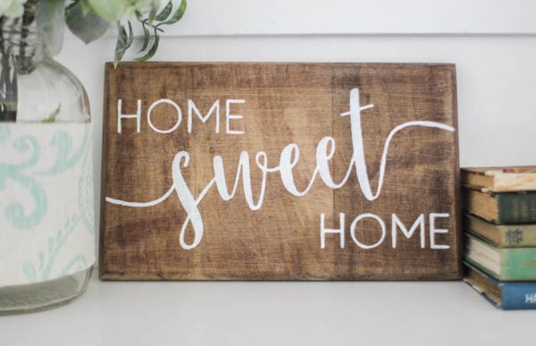 wood sign with white letters saying home sweet home