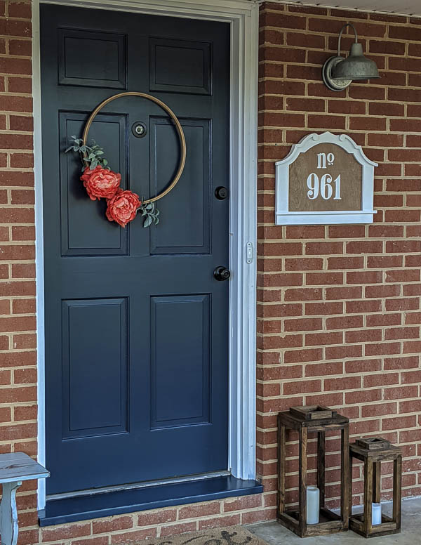 diy house number on front porch with navy front door and brick walls