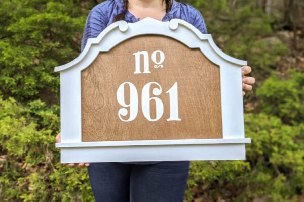 diy house number made from a painted frame and stained plywood with painted on numbers.