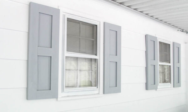 aluminum windows painted white with gray shutters