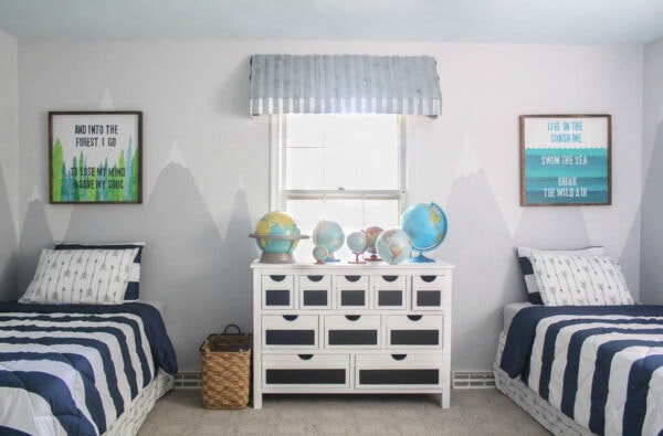 boys shared bedroom with white dresser, two twin beds, globe collection, and DIY wooden signs