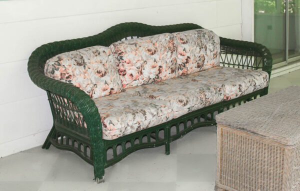 green wicker sofa on porch