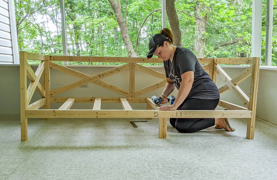 Carrie attaching slats to diy daybed.