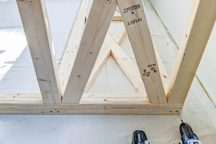 attaching the side of the daybed to the back with a drill.