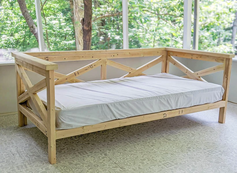 wooden daybed with twin mattress.