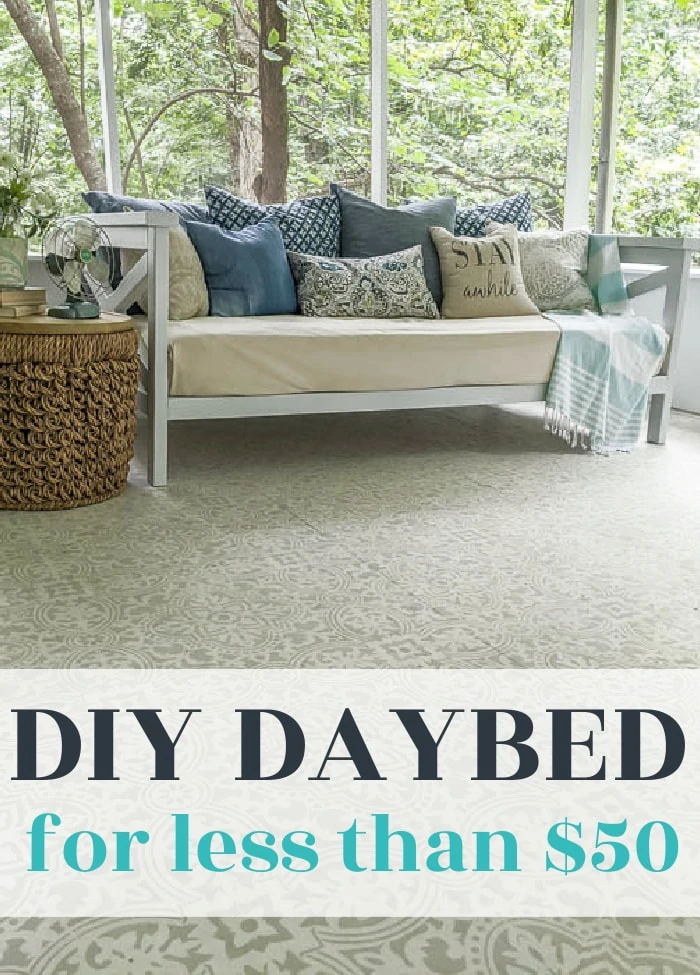 diy wooden daybed on a porch with pillows and basket side table.