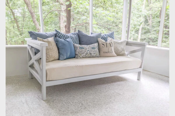diy wooden daybed on screened-in porch.